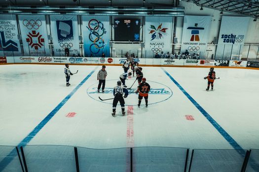 Televisiescherm met schaatsen vandaag olympische spelen en kijkers uit Hardenberg die een samenvatting volgen